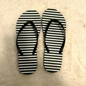 Black and White striped flip flops.